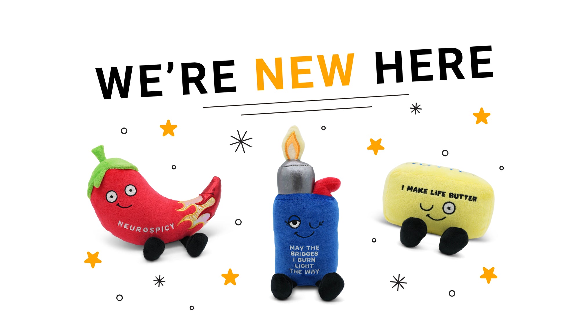 Three plush toys resembling a red pepper, blue bottle, and yellow block with text 'WE'RE NEW HERE' above them on a white background.