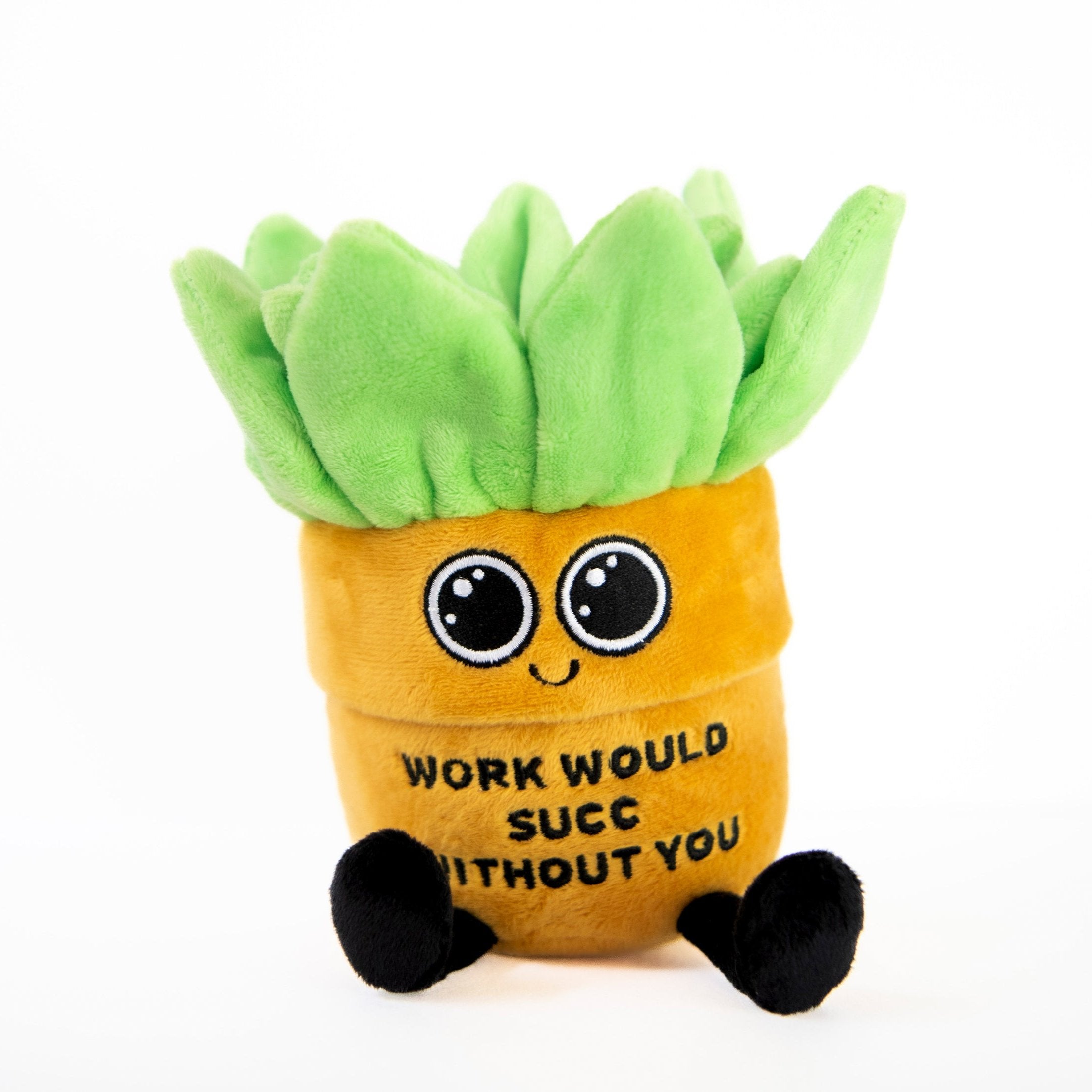 A plush designed to look like a plant with a smiling face and dangly legs, with a text on its base saying 'WORK WOULD SUCC WITHOUT YOU'.