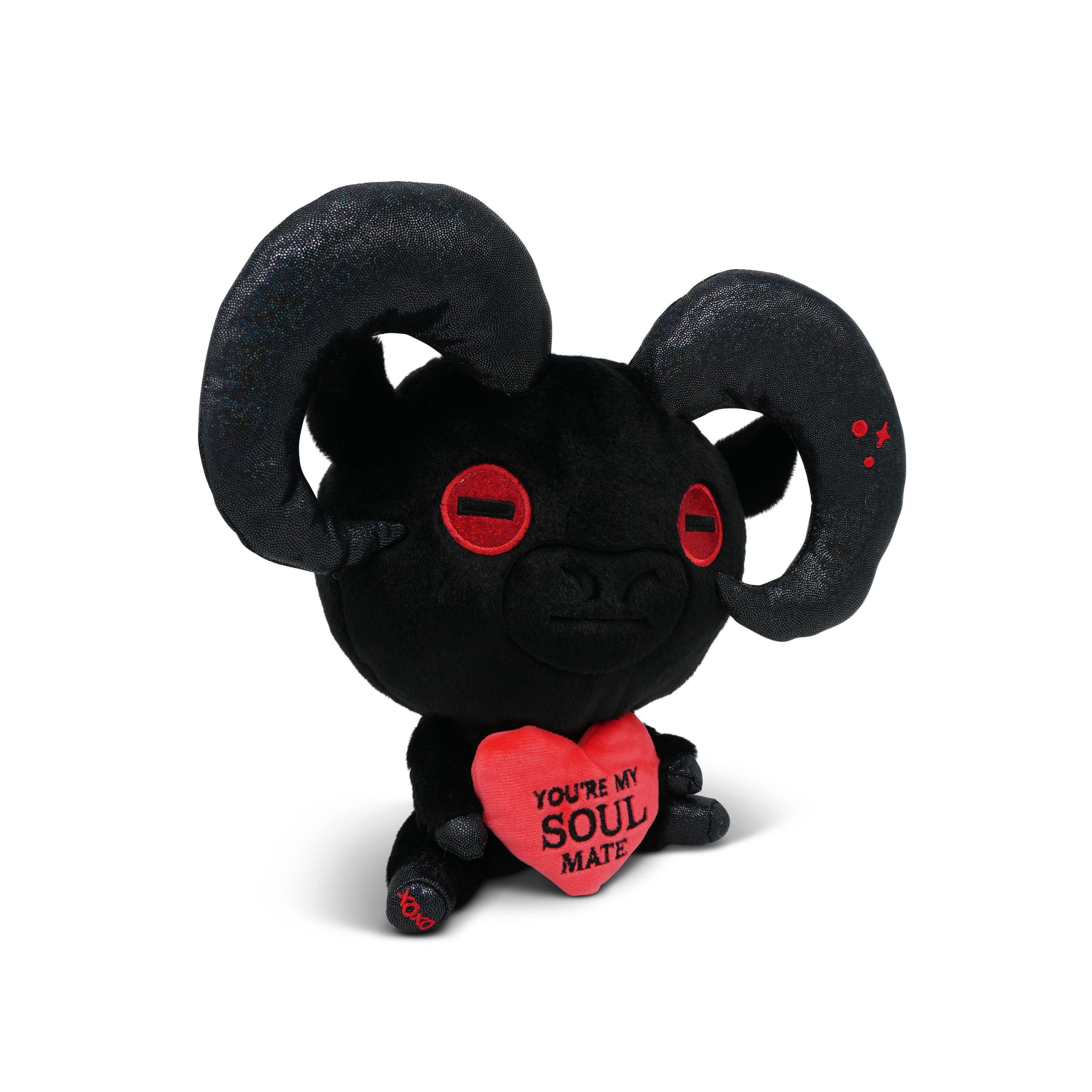 Black plush of a devil goat with red eyes and a heart saying 'You're my soul mate' on a white background