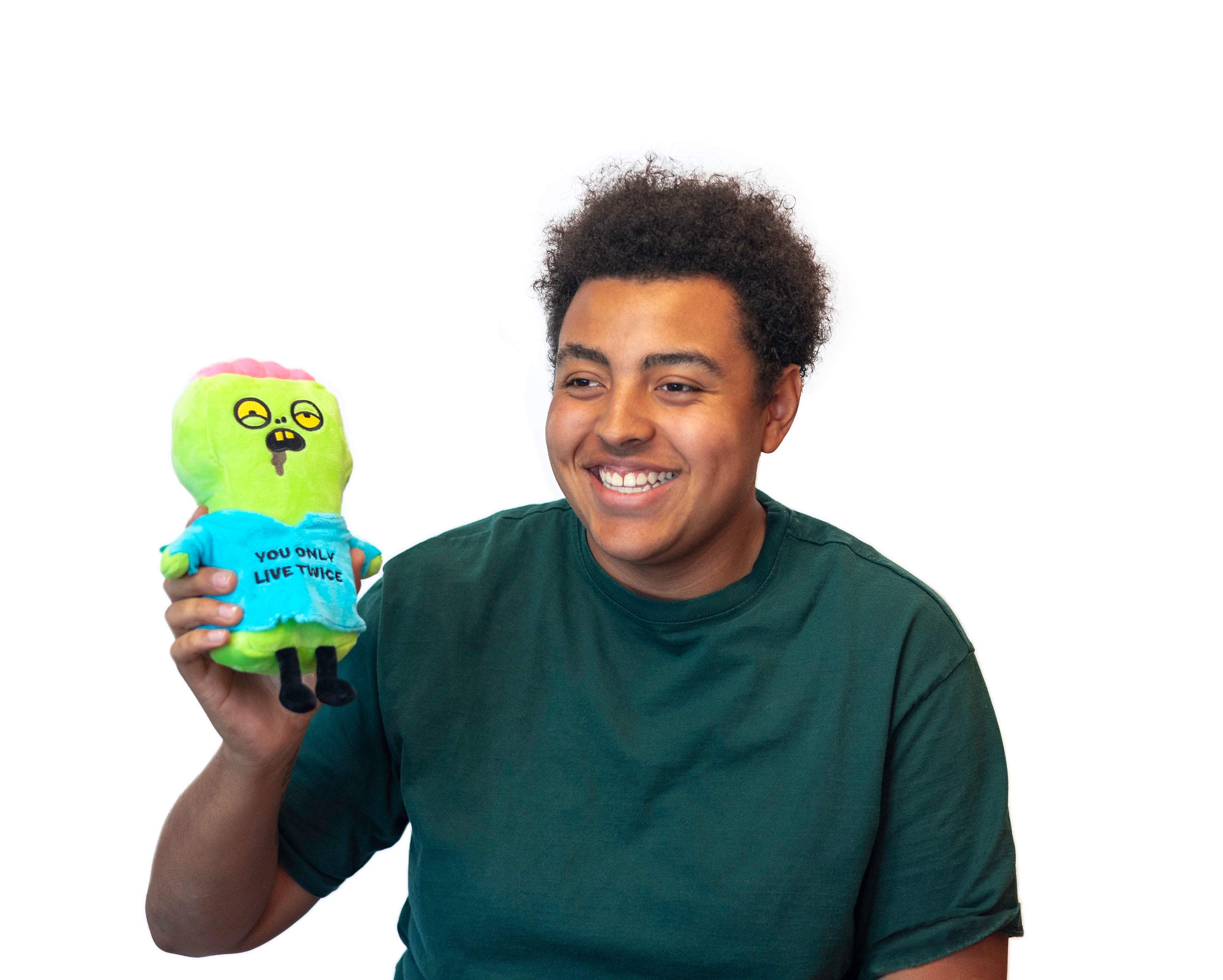 A man holding a plush zombie wearing a blue shirt with the text 'YOU ONLY LIVE TWICE'.